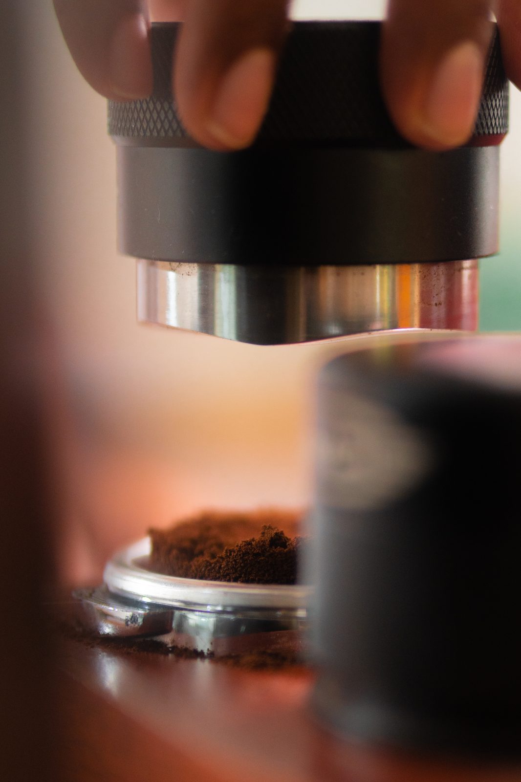 Tamping ground coffee