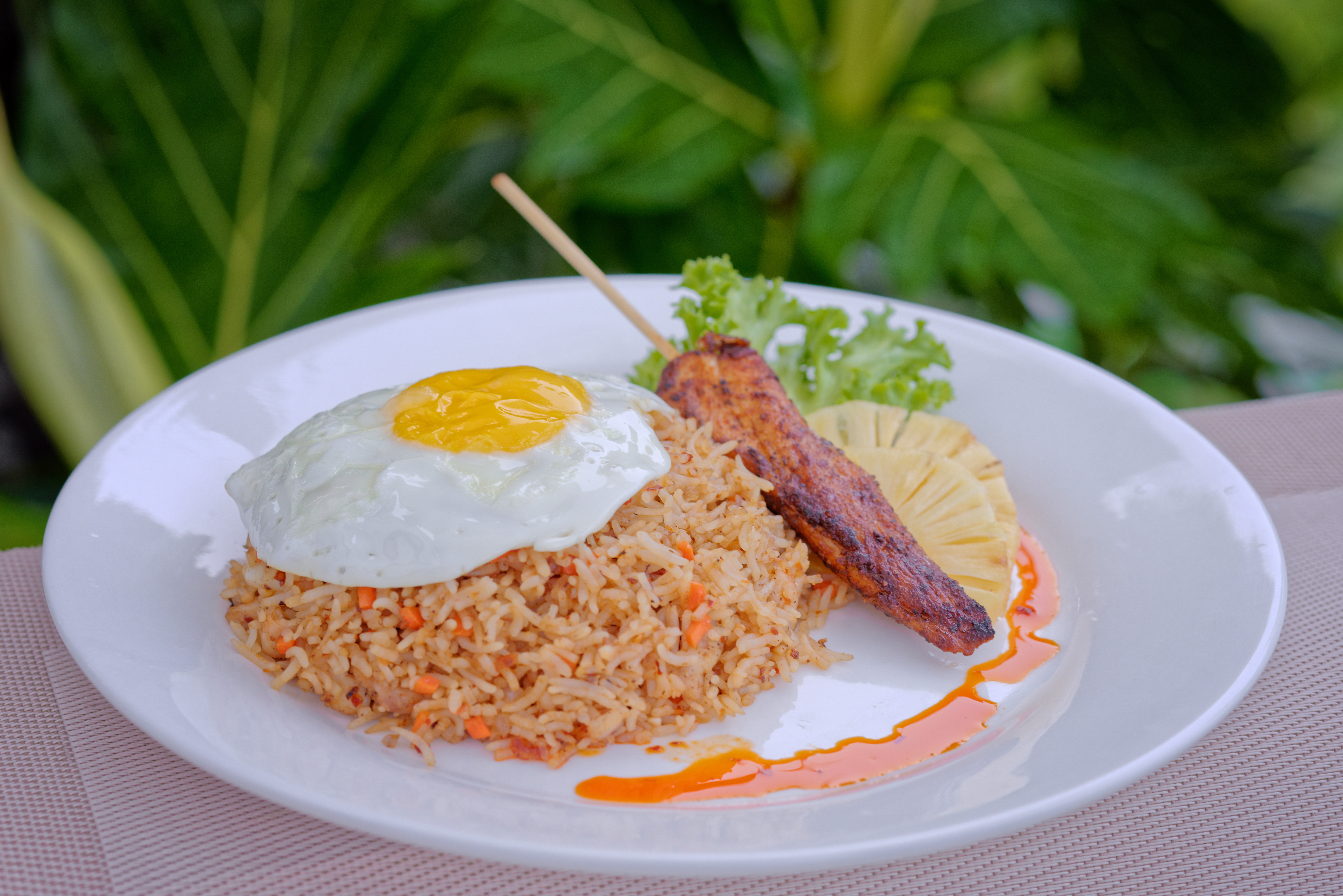 Nasi Goreng with chicken satay, sunny-side egg and grilled pineapple at Luau Restaurant