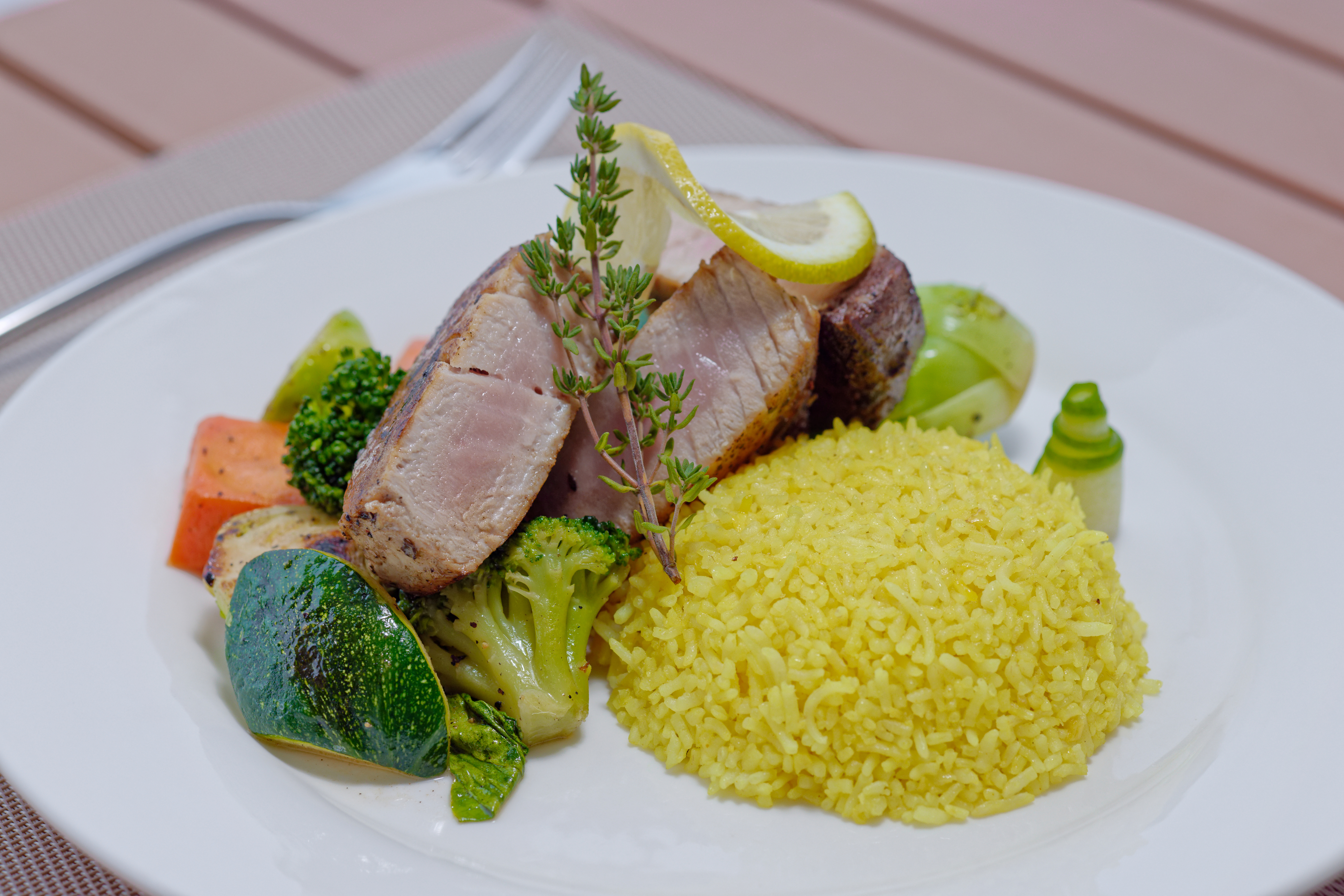Seared yellowfin tuna with saffron rice and grilled garden vegetables at Luau Restaurant